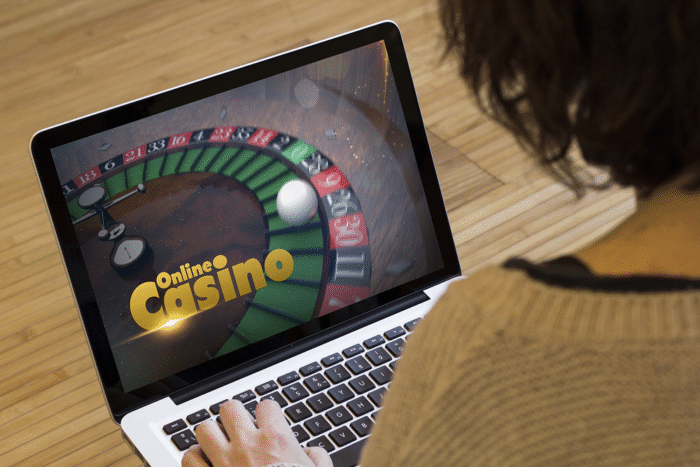 Real-time monitoring and analytics in iGaming compliance automation displayed on a laptop for casino operations.